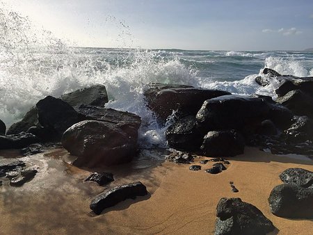 Waves crashing over the black lava rocks on the beach in Kapaa, Kauai, Hawaii Stock Photo - Budget Royalty-Free & Subscription, Code: 400-09222612