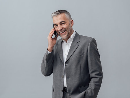 simsearch:400-08750050,k - Confident smiling businessman having a phone call with his smartphone Stock Photo - Budget Royalty-Free & Subscription, Code: 400-09222944