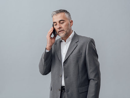 simsearch:400-08159440,k - Confident businessman having a phone call with his smartphone Stock Photo - Budget Royalty-Free & Subscription, Code: 400-09222943