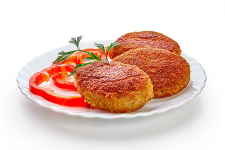 Three fried breaded cutlet with lettuce and parsley isolated on white background Stock Photo - Budget Royalty-Free & Subscription, Code: 400-09223005