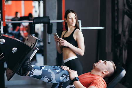 Fit man training legs on leg press machine in the gym. Sport activities Stock Photo - Budget Royalty-Free & Subscription, Code: 400-09223218