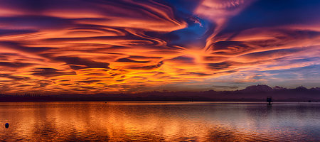 Incredible lenticular clouds in the sky during a sunset over the Varese lake Stock Photo - Budget Royalty-Free & Subscription, Code: 400-09223895