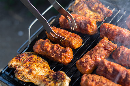 Close up of traditional Romanian food made of pork/beaf meat called mici or mititei fried on mangal barbeque grill Stock Photo - Budget Royalty-Free & Subscription, Code: 400-09237515
