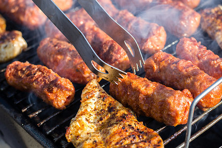 Close up of traditional Romanian food made of pork/beaf meat called mici or mititei fried on mangal barbeque grill Stock Photo - Budget Royalty-Free & Subscription, Code: 400-09237516