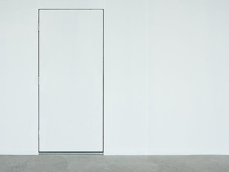 A closed white door on the white wall which located on the back side of the  warehouse. Foto de stock - Royalty-Free Super Valor e Assinatura, Número: 400-09237534