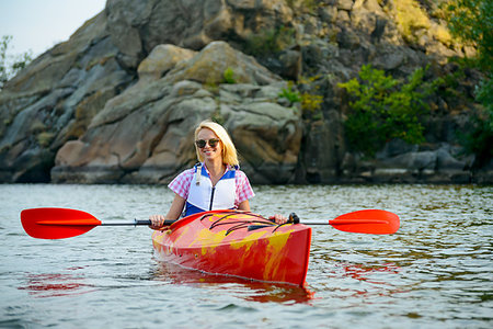simsearch:400-05362222,k - Young Woman Paddling Kayak on the Beautiful River or Lake among Stones at the Evening Stock Photo - Budget Royalty-Free & Subscription, Code: 400-09237567