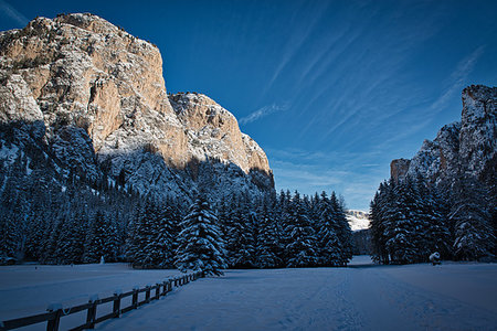 Winter panorama in the valley with sunny mountains on the left and forest in the shadow, Dolomites Stock Photo - Budget Royalty-Free & Subscription, Code: 400-09237635
