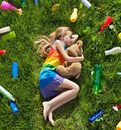 simsearch:400-04491217,k - Young girl sleeping with her teddy bear in the plastic littered grass - pollution concept Photographie de stock - Aubaine LD & Abonnement, Code: 400-09237770