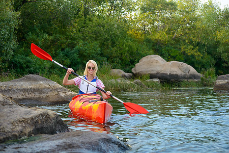 simsearch:400-05362222,k - Young Woman Paddling Kayak on the Beautiful River or Lake among Stones at the Evening Stock Photo - Budget Royalty-Free & Subscription, Code: 400-09237799