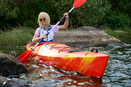 simsearch:400-05362222,k - Young Woman Paddling Kayak on the Beautiful River or Lake among Stones at the Evening Stock Photo - Budget Royalty-Free & Subscription, Code: 400-09237800