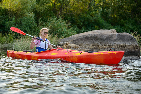 simsearch:400-05362222,k - Young Woman Paddling Kayak on the Beautiful River or Lake among Stones at the Evening Stock Photo - Budget Royalty-Free & Subscription, Code: 400-09237803