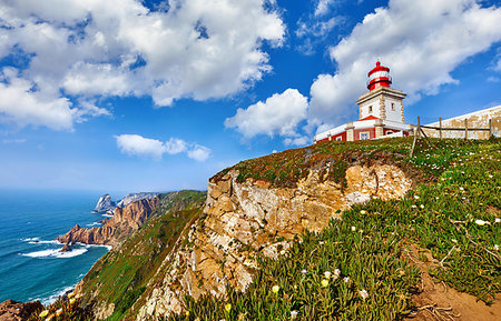 Lighthouse at Cape Roca (Cabo da Roca), most western point of Europe at coast of Atlantic Ocean in Portugal. Rocks at coastline and blue sky with clouds over skyline. Picturesque summer landscape. Stock Photo - Budget Royalty-Free & Subscription, Code: 400-09238010