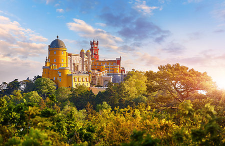 National Palace of Pena in Sintra, near Lisbon, Portugal. Picturesque landscape with dawn and green trees. Blue morning sky with clouds. Photographie de stock - Aubaine LD & Abonnement, Code: 400-09238098