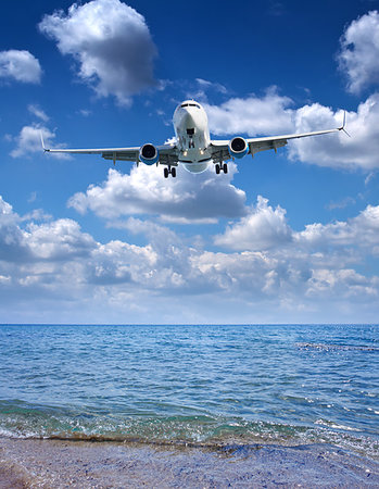 simsearch:400-06481445,k - Passenger airplane prepare for landing on sunny mediterranean sea and sky background Photographie de stock - Aubaine LD & Abonnement, Code: 400-09238090