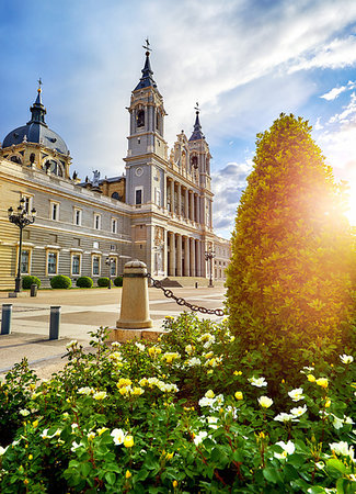 Madrid, Spain. Cathedral Santa Maria la Real de la Almudena at Plaza de la Armeria. Famous landmark with sunset sun flowers and green bush. Stock Photo - Budget Royalty-Free & Subscription, Code: 400-09238263