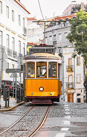 Lisbon, Portugal. Vintage yellow retro tram on narrow bystreet tramline in Alfama district of old town. Popular touristic attraction of Lisboa city. Photographie de stock - Aubaine LD & Abonnement, Code: 400-09238331