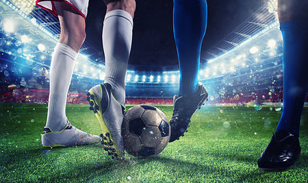 simsearch:400-09032434,k - Soccer players with soccerball at the illuminated stadium during the match Stockbilder - Microstock & Abonnement, Bildnummer: 400-09274461