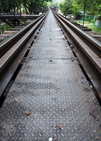 simsearch:400-05883568,k - Closeup of the metal pathway on the old railway bridge with the blur trourist background, Kanchanaburi Thailand. Photographie de stock - Aubaine LD & Abonnement, Code: 400-09274533