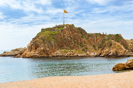 simsearch:851-02963102,k - Rock Sa Palomera and sandy coast of Spanish beach resort Blanes in summertime. Costa Brava, Catalonia, Spain. Spanish flag flutters on a flagpole on top of a rock Stock Photo - Budget Royalty-Free & Subscription, Code: 400-09274761