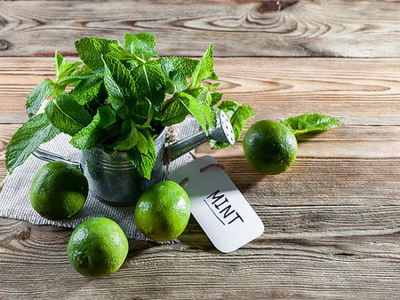 Fresh mint leaves in a vintage watering can and green limes on a wooden background. Stock Photo - Budget Royalty-Free & Subscription, Code: 400-09275047