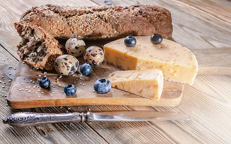 sandwich rustic table - Baguette, cheese with spices and herbs, quail eggs, blueberries. Tasty and healthy bio food concept Stock Photo - Budget Royalty-Free & Subscription, Code: 400-09275048