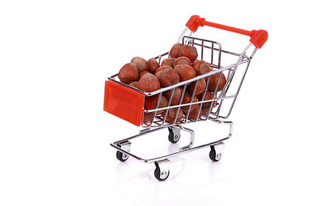 Nuts in miniature shopping cart isolated on white background Fotografie stock - Microstock e Abbonamento, Codice: 400-09275272