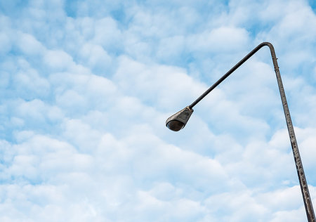 High street light pole under the couldy sky near the urban area.(Copy space). Foto de stock - Royalty-Free Super Valor e Assinatura, Número: 400-09275508