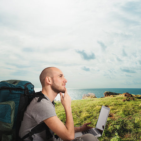 simsearch:400-09273583,k - Explorer man plans a new travel to a tropical beach with his laptop Stockbilder - Microstock & Abonnement, Bildnummer: 400-09273584