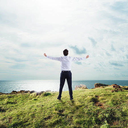 simsearch:6109-06195330,k - Businessman in a mountain with open arms to the sky. concept of success and freedom Photographie de stock - Aubaine LD & Abonnement, Code: 400-09273582