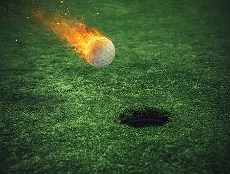 Fiery golf ball near the hole in a green grass field Stock Photo - Budget Royalty-Free & Subscription, Code: 400-09273595