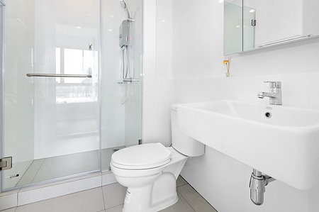 Very clean white bathroom in condominium Stock Photo - Budget Royalty-Free & Subscription, Code: 400-09273910
