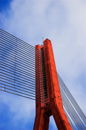 simsearch:845-02729530,k - Modern Red Cable bridge closeup on blue sky Photographie de stock - Aubaine LD & Abonnement, Code: 400-03907956