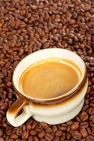 simsearch:700-06431318,k - Coffee beans around cup of coffee. Focus is on the top of the cup. Small depth of field Stock Photo - Budget Royalty-Free & Subscription, Code: 400-03908646