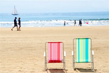 simsearch:400-03941660,k - Two empty colorful beach chairs on a sandy beach Stock Photo - Budget Royalty-Free & Subscription, Code: 400-03908663