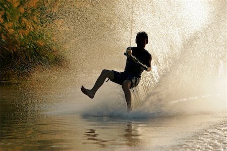 Silhouette of a barefoot skier with backlit water spray Stock Photo - Budget Royalty-Free & Subscription, Code: 400-03908755