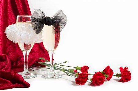 simsearch:614-03903091,k - two glasses of champagne with white and black bow knots, carnation and red velvet on white background with copyspace. Stock Photo - Budget Royalty-Free & Subscription, Code: 400-03908764
