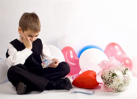 simsearch:400-03967457,k - The boy reflects on a congratulation to the Valentine's day. Multi-coloured balloons around Foto de stock - Royalty-Free Super Valor e Assinatura, Número: 400-03908794