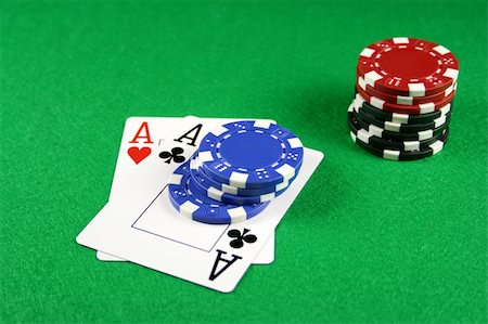 Playing cards showing a pair of aces with poker chips next to them Stock Photo - Budget Royalty-Free & Subscription, Code: 400-03909401