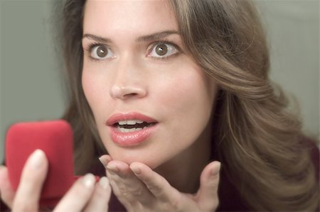 Pretty brunette is very happy to receive a present in a red box Stock Photo - Budget Royalty-Free & Subscription, Code: 400-03909418