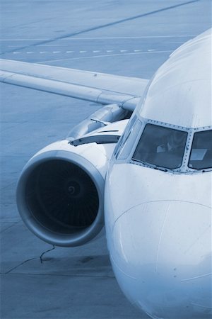 simsearch:700-03778516,k - Parked plane with blue filter. Tarmac floor is rough, not noise. Photographie de stock - Aubaine LD & Abonnement, Code: 400-03909428