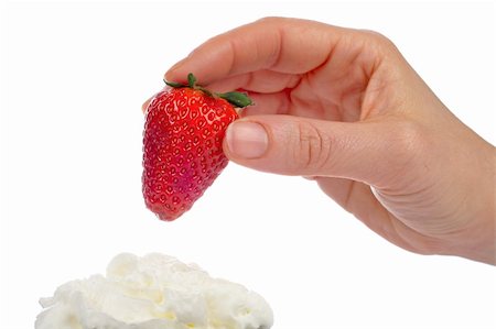 simsearch:400-03920561,k - Woman hand with a fresh juicy strawberry over a cream Photographie de stock - Aubaine LD & Abonnement, Code: 400-03914546