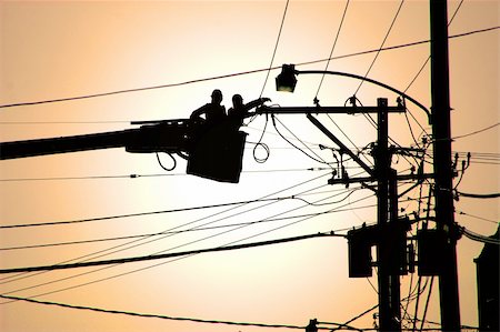 simsearch:614-06624706,k - Two utility service workers in a cherry picker working on electrical power lines. Photographie de stock - Aubaine LD & Abonnement, Code: 400-03914619