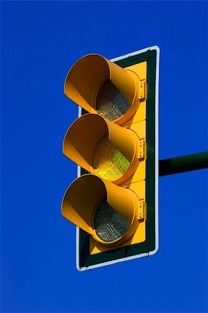 Yellow traffic light on blue sky Stock Photo - Budget Royalty-Free & Subscription, Code: 400-03915221