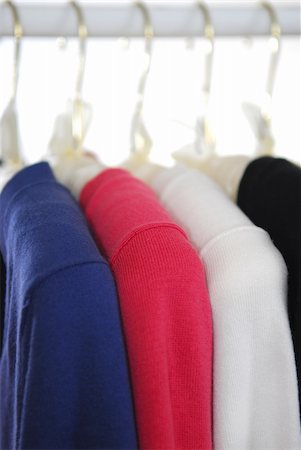 Colorful women's sweaters on a rack on padded hangers Stock Photo - Budget Royalty-Free & Subscription, Code: 400-03915447