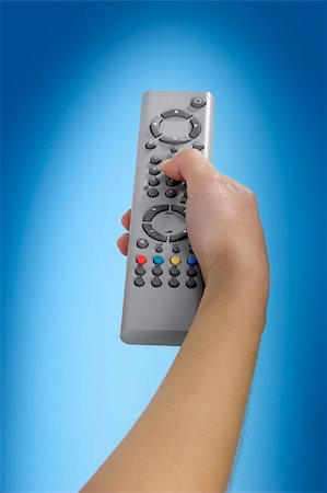 film equipment - Human hand olding a tv remote control Foto de stock - Super Valor sin royalties y Suscripción, Código: 400-03915490