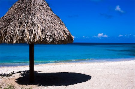 simsearch:400-04045508,k - Beautifull white, sandy, tropical beach with a typical straw umbrella for shade, and cristal clear blue, green water. Stock Photo - Budget Royalty-Free & Subscription, Code: 400-03915706