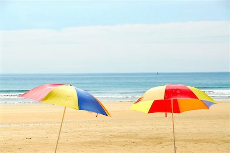 simsearch:400-03941660,k - Two beach ubrella standing on ocean shore Stock Photo - Budget Royalty-Free & Subscription, Code: 400-03915759