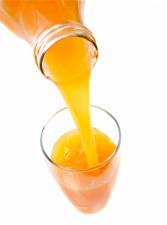 Pouring fresh orange juice into a glass on white background Stockbilder - Microstock & Abonnement, Bildnummer: 400-03916186