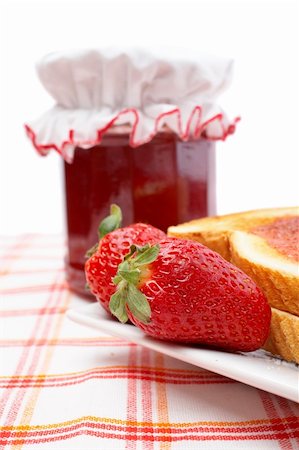 simsearch:700-02594044,k - Two strawberries and toasts in a dish, in front of jam jar. Shallow DOF Stock Photo - Budget Royalty-Free & Subscription, Code: 400-03916183