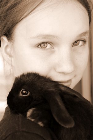 rabbit face closeup - Portrait of a young girl holding a black baby rabbit in sepia Stock Photo - Budget Royalty-Free & Subscription, Code: 400-03916432